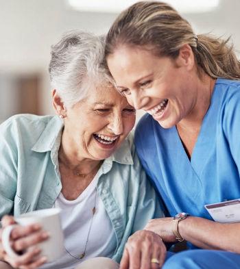 female elderly client female caregiver laughing